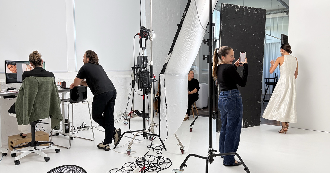The PHOTOWORKS team on a fashion eCommerce shoot in their Sydney studio — photographer, retoucher, and stylist at work.